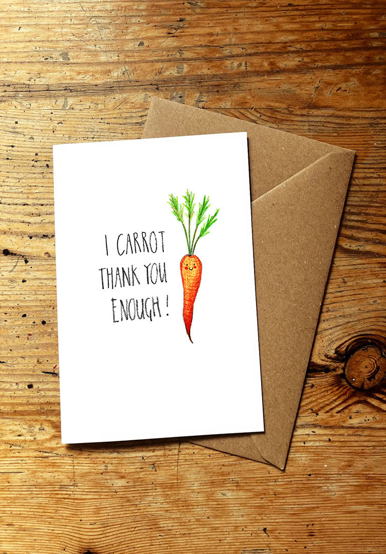 Veg pun greeting card with a smiley carrot illustration and text on a wooden surface
