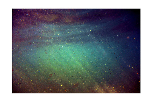 sand particles catching sunlight as they shimmer and float underwater