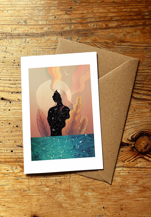 Greeting card with a design of a woman's silhouette standing in the sea on a wooden surface