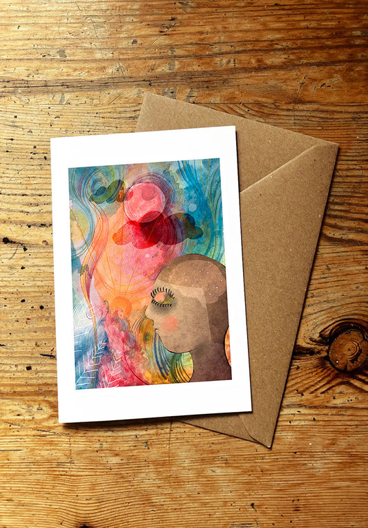 Greeting card with a colourful surreal illustration on a wooden surface