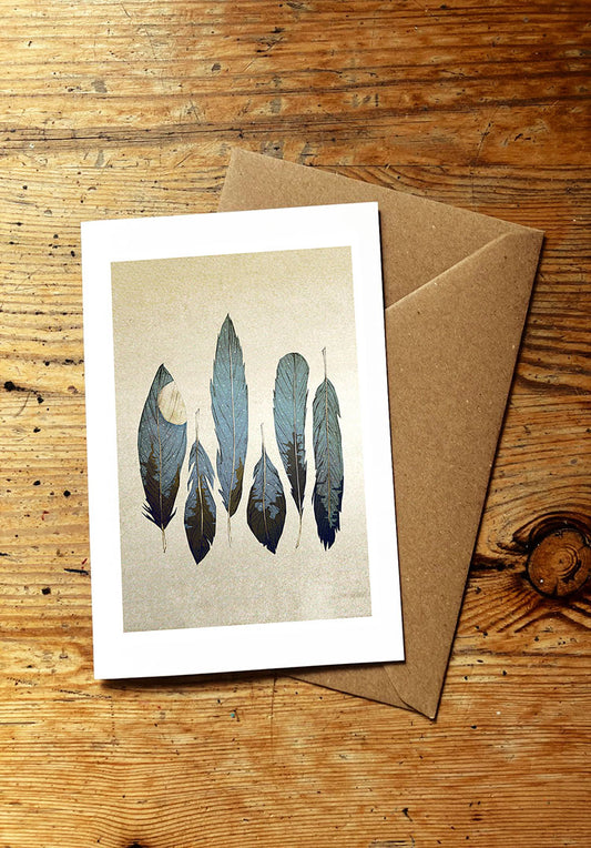 Greeting card with feather design on a wooden surface