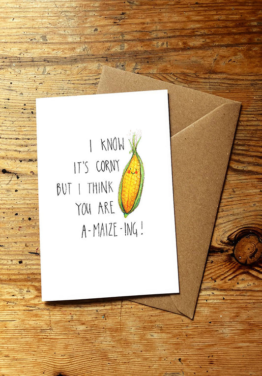 Veg pun greeting card with smiley corn illustration and text on a wooden surface