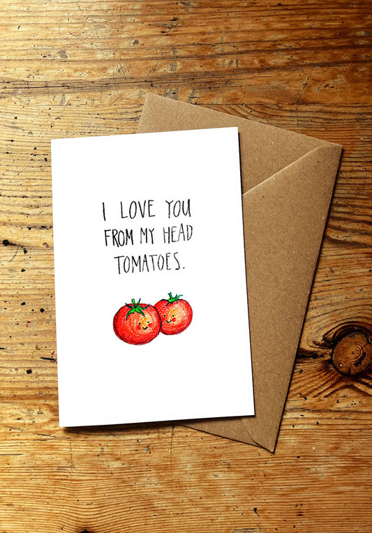 Veg pun greeting card with 'I love you from my head tomatoes' text and two smiley tomatoes on a wooden surface