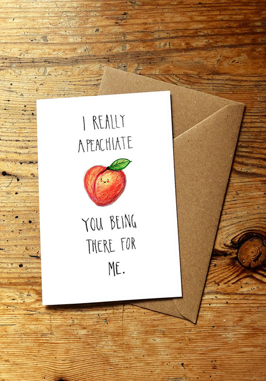 Fruit and veg pun card with a smiley peach illustration and text on a wooden surface