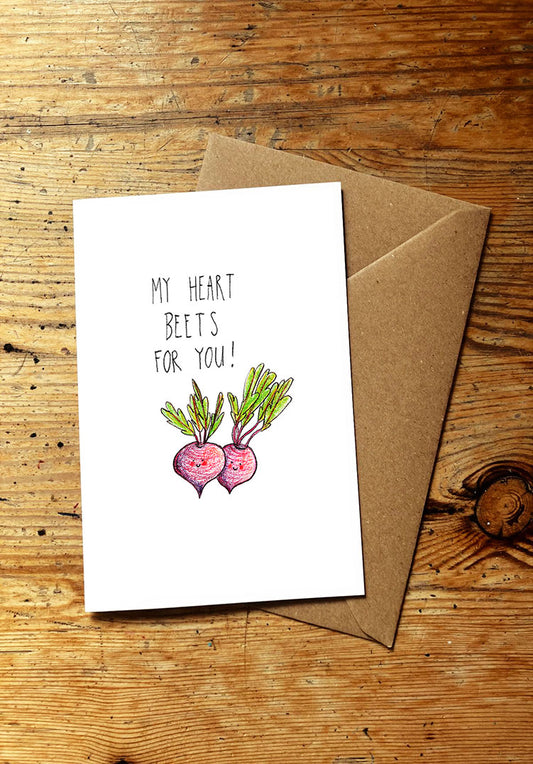 Veg pun greeting card with 'My heart beets for you!' text and smiley beet illustration on a wooden surface