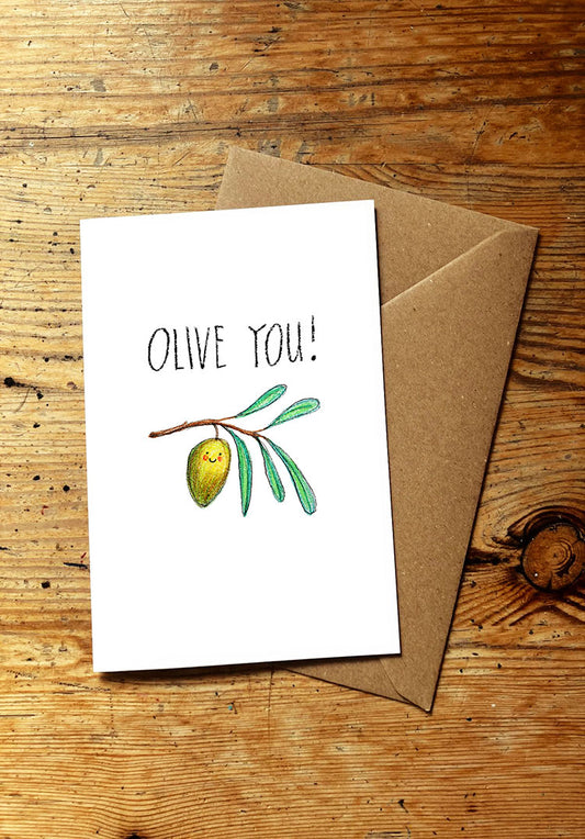 Veg pun greeting card with 'Olive You!' text and smiley olive illustration on a wooden surface