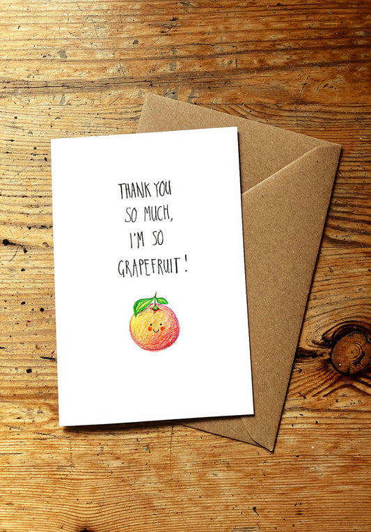 Fruit and veg pun greeting card with a smiley grapefruit illustration and text on a wooden surface