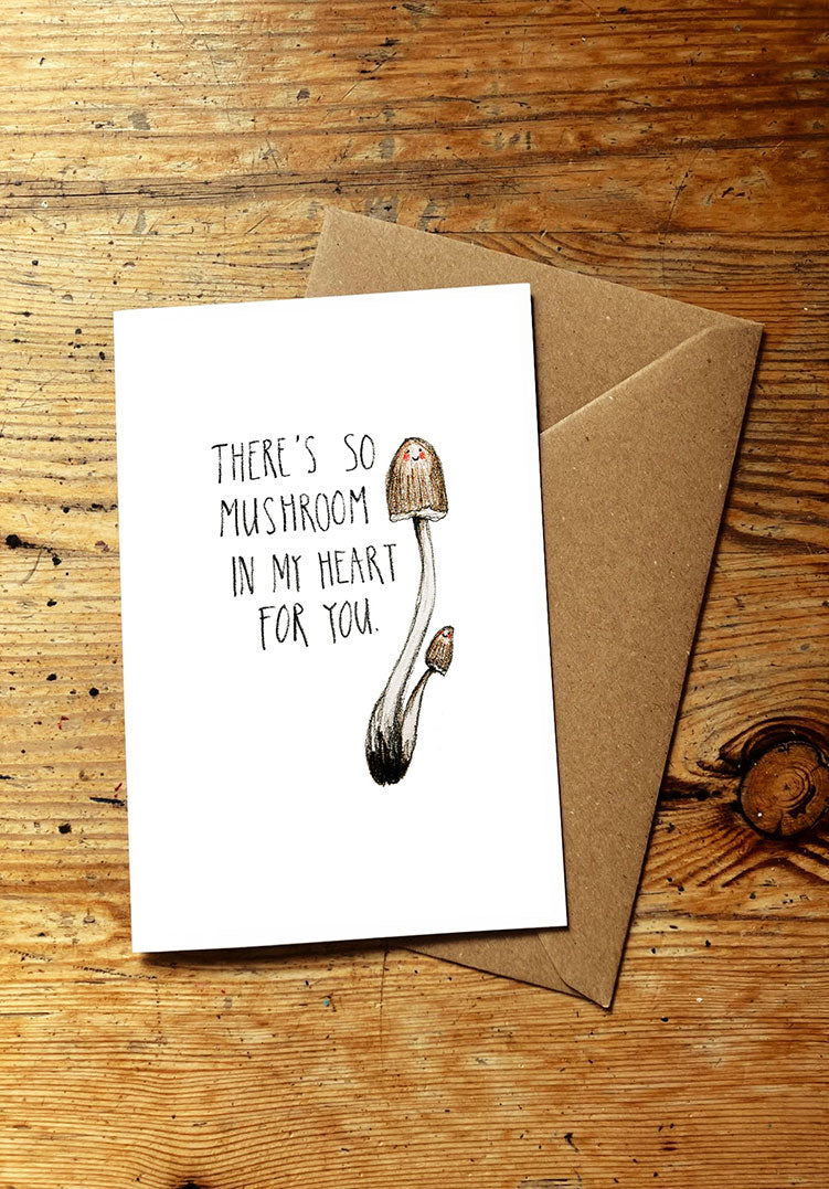 Veg pun greeting card with mushroom illustration and text on a wooden surface