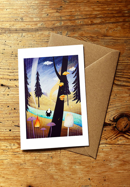 Greeting card with nature-themed illustration on a wooden surface