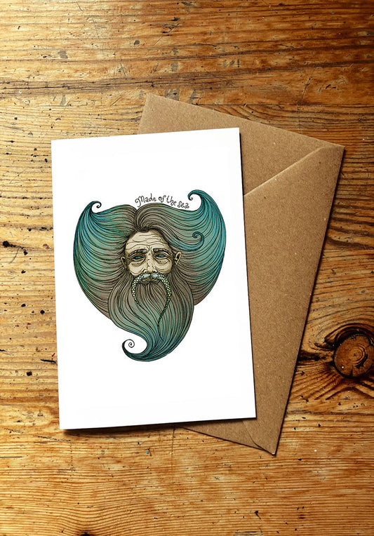 Greeting card with a beard and sea themed illustration on a wooden surface