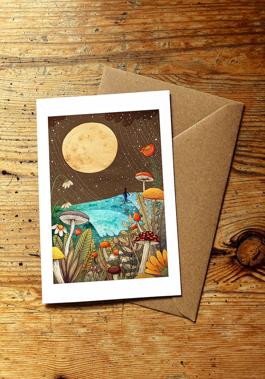 Greeting card with surf art and mushroom and full moon illustration on a wooden surface