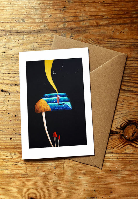 Greeting card with a mushroom and surf girl design on a wooden surface