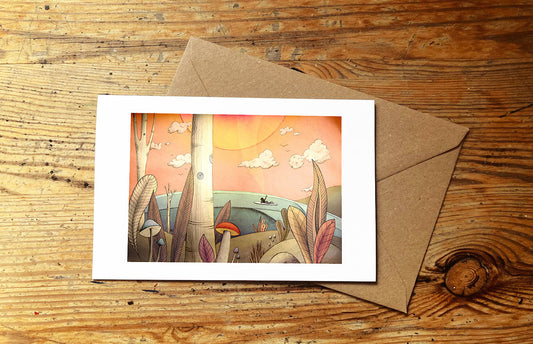 Greeting card with surf girl and mushrooms and nature scene, with an envelope on wooden surface