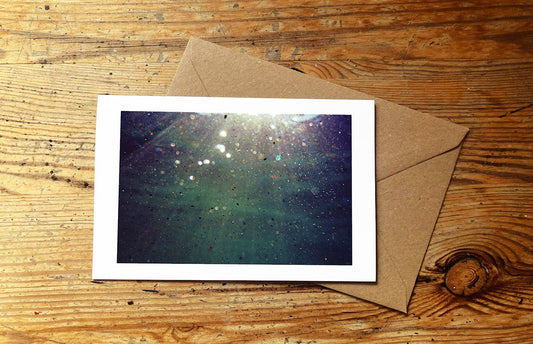 Greetings card with an underwater photo design on a wooden surface