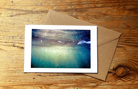 Greeting card with an underwater photo design on a wooden surface