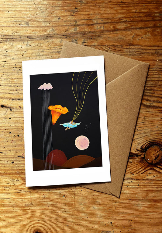Greeting card with a wild swimming, mushroom and moon design on a wooden surface
